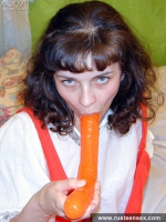Teen brunette masturbates with orange dildo
