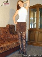 Pantyhosed teen girl shows nyloned legs