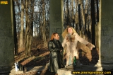 Two girls outdoor pissing on stone columns