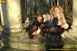 Two girls outdoor pissing on stone columns
