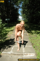Outdoor pissing of walking naked blonde