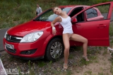 Girl posing near car