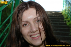 Outdoor pissing of teen brunette on a concrete park ladder - N