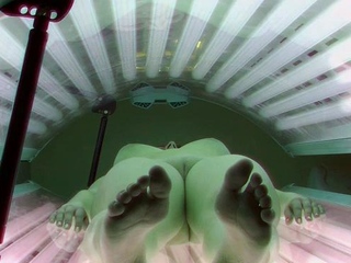 Busty brunette in solarium